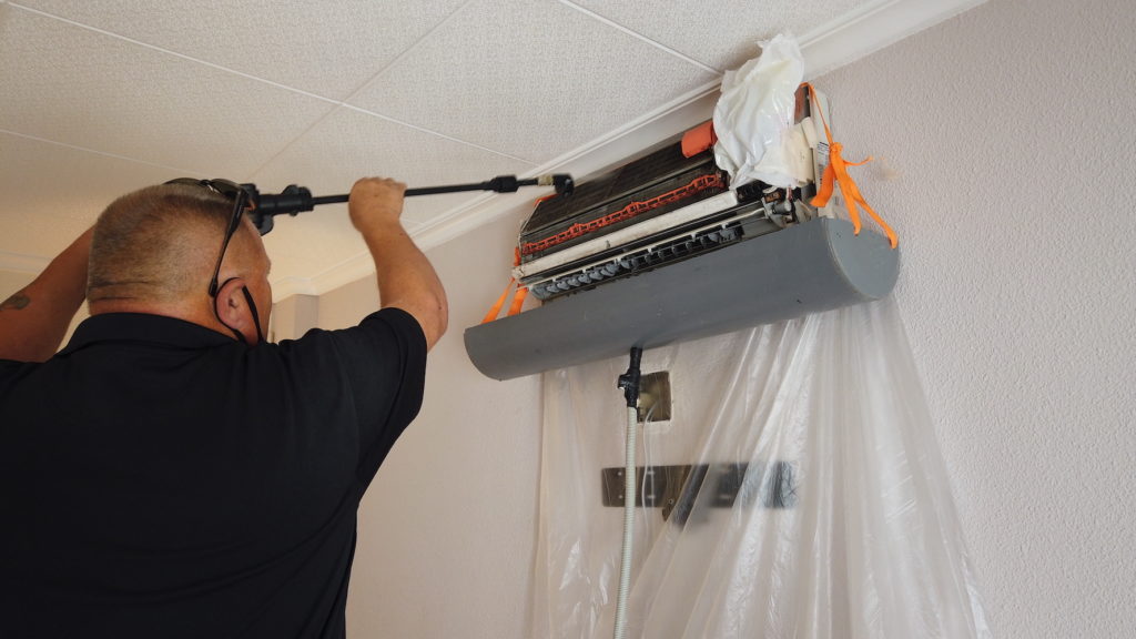 EuroCool engineer servicing a wall-mounted air conditioning unit on the Costa Blanca